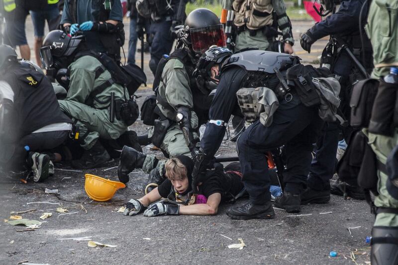 Police detain demonstrators in the Sha Tin district of Hong Kong. Photograph:  Isaac Lawrence / AFP