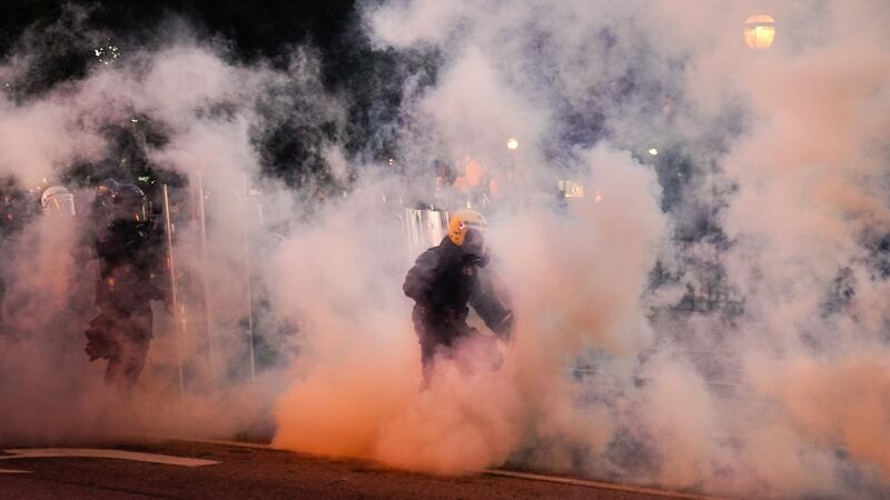 Police advance through a cloud of tear gas during a protest in response to the police killing of George Floyd in Atlanta, Georgia. Photograph: Elijah Nouvelage/Getty Images
