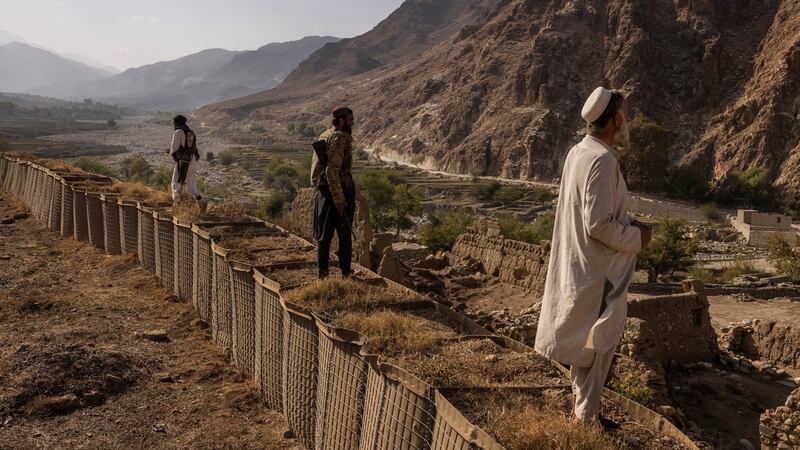 Taliban fighters  look over the Mohmand Valley from an abandoned US special forces base in the Achin District of Afghanistan’s Nangarhar province. Photograph: Victor J Blue/The New York Times
