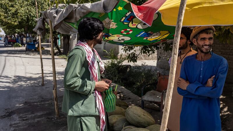 Abdul Aleem (right) at his watermelon stand in Kunduz. Photograph: Jim Huylebroek/ New York Times