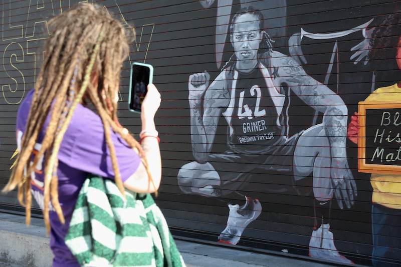 A Phoenix Mercury fan photographs mural depicting Brittney Griner outside the team's home stadium in December. Photograph: Christian Petersen/Getty Images)