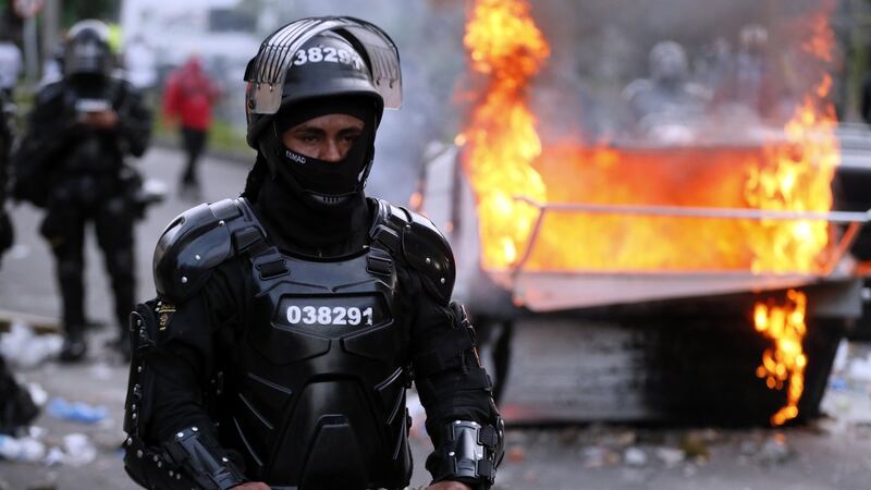 A Colombian police officer in riot gear during clashes with demonstrators during a protest organised following Javier Ordonez’s death  in Bogota. Photograph: EPA