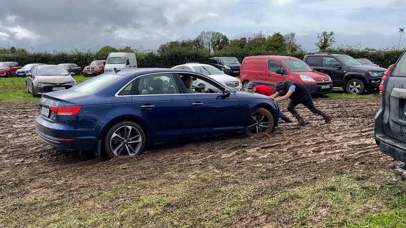 A stuck car is pushed out of the mud on Tuesday. Photograph: Niall Carson/PA Wire 