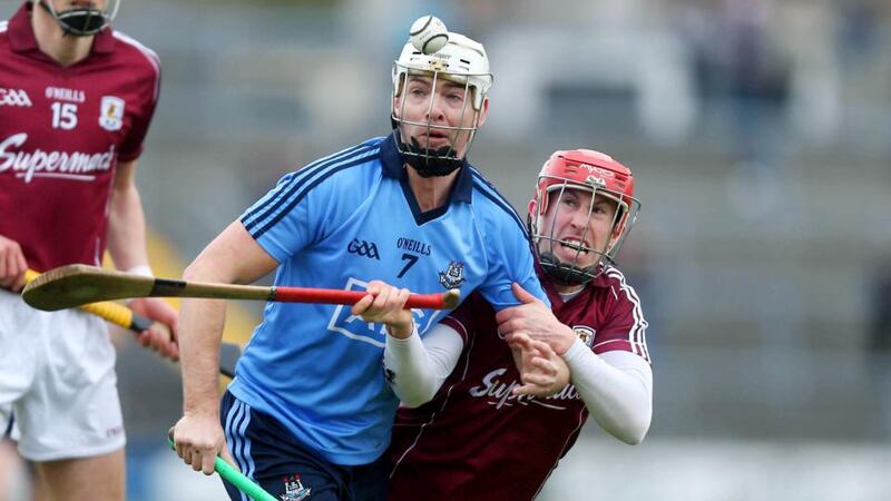 Niall Healy of Galway (right) with Michael Carton of Dublin at Pearse Stadium. Photograph: Donall Farmer/Inpho