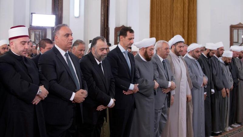 Syrian president Bashar al-Assad (centre)   at the al-Safa Mosque in Tareeq al-Sham (Damascus Road) neighborhood in Homs province, Syria. Photograph: Sana/EPA