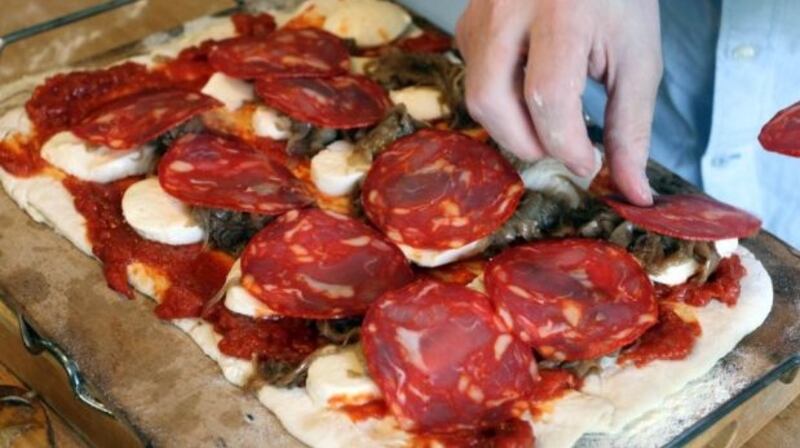 Fully loaded: pizza with mozzarella, chorizo, caramelised fennel and onions, rocket and Parmesan.