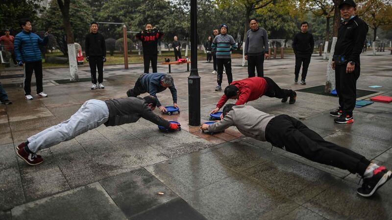 Elderly men exercise in a park in Wuhan, China’s central Hubei province on Saturday, one year after the city went into lockdown to curb the spread of the Covid-19 coronavirus. Photograph: Hector Retamal/AFP/Getty Images