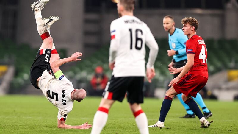 Dundalk’s Chris Shields takes a tumble during the Europa League Group B match against Rapid Vienna at the Aviva stadium. Photograph: Tommy Dickson/Inpho