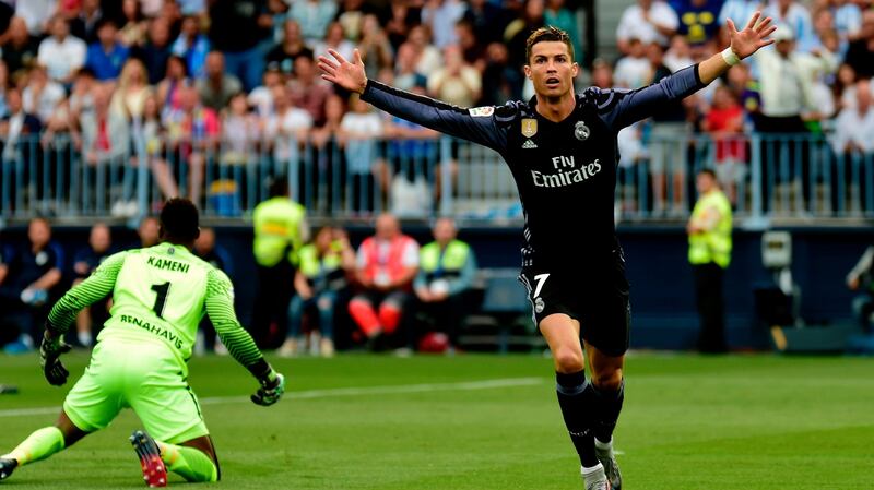 Cristiano Ronaldo scores the first goal against Malaga at La Rosaleda stadium. Photograph: Getty Images