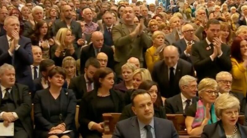 Mary Lou McDonald look at each other before joining the standing ovation
