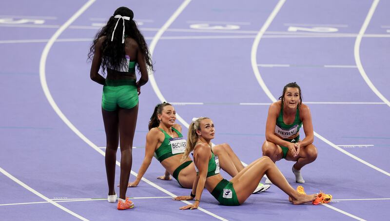 Rhadisat Adeleke, Sophie Becker, Phil Healy and Sharlene Mawdsley dejected after they finished in fourth place in the women's 4x400m relay Olympic final. Photograph: Ryan Byrne/Inpho 