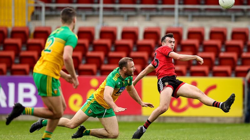 Down’s Conor McCrickard is challenged by Donegal’s Neil McGee. Photograph: Tommy Dickson/Inpho