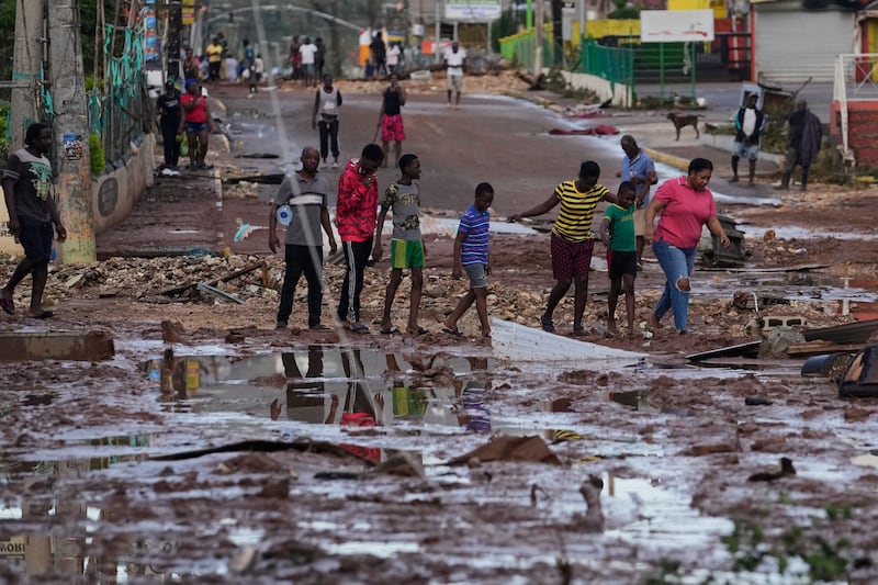 People walk through Santa Cruz, Jamaica, in the aftermath of  Hurricane Melissa. Photograph: Matias Delacroix/AP