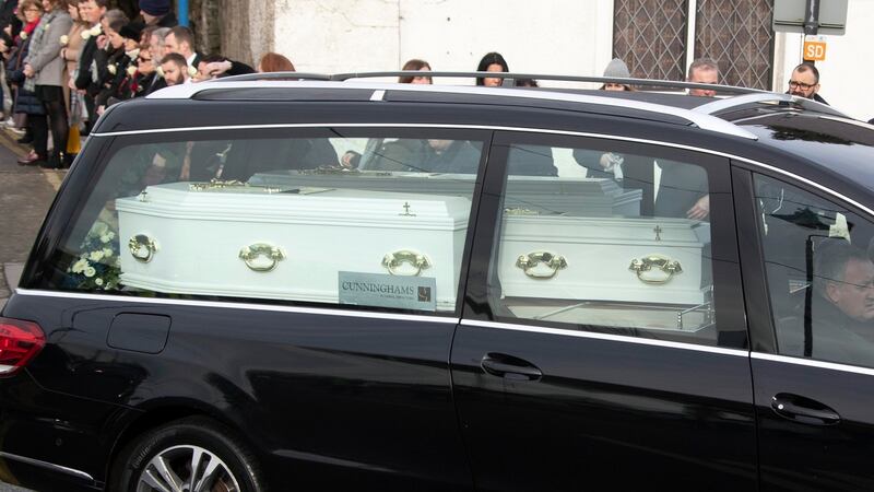 The hearse bearing the three coffins leaves the church after the funeral Mass for Conor (9), Darragh (7) and Carla (3) McGinley, who were found dead at their home on Friday, January 24th. Photograph: Collins