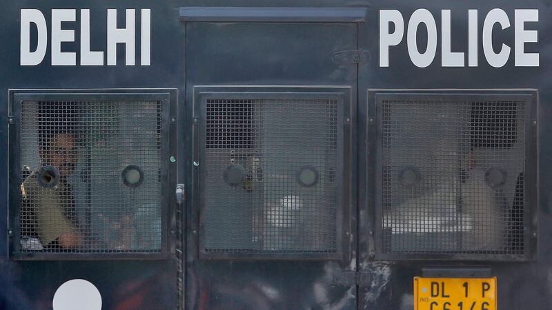 Police stand at the entrance of a court after four men convicted of raping and murdering a 23-year-old woman in Delhi were sentenced to death in New Delhi today. REUTERS/Ahmad Masood