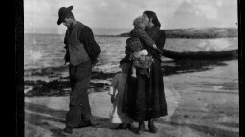 Photograph of an Inis Oírr family walking on the shore, taken by JM Synge. Photograph: The Board of Trinity College Dublin