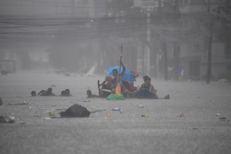 Rescuers paddle their boats along a flooded street in Manila on July 24th Photograph: Getty Images