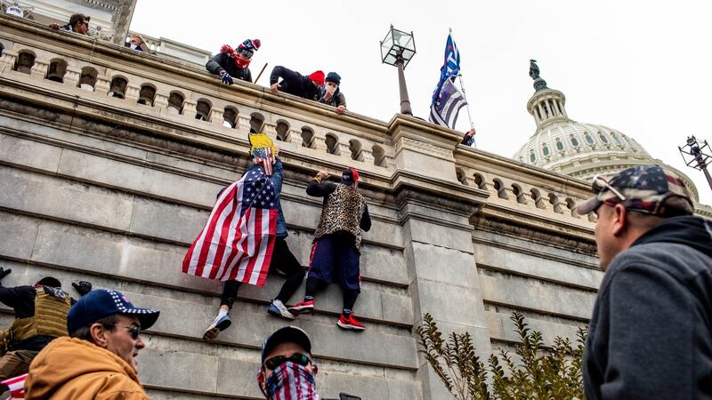 Protesters climb the Capitol in Washington. Photograph: Jason Andrew/The New York Times
