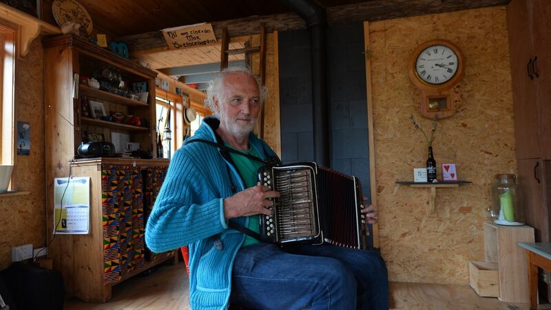 Musician Breanndán Ó Beaglaoich in the tigín  he built on a truck chassis. Kerry County Council have asked him to move his home off the site in Baile Na bPoc in west Kerry. Photograph: Domnick Walsh