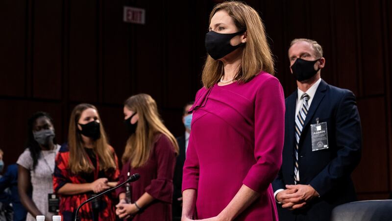 Judge Amy Coney Barrett stands with her family after the first day of her senate confirmation hearing. Photograph: Erin Schaff/Pool/EPA