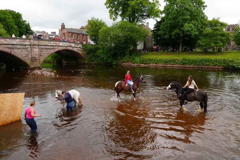 People washing horses in river Eden during the Appleby Horse Fair. Photograph: Owen Humphreys/PA Wire 