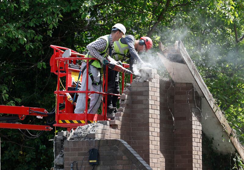 Workers remove the remains of the derelict buildings in south Dublin. Photograph: Nick Bradshaw/The Irish Times