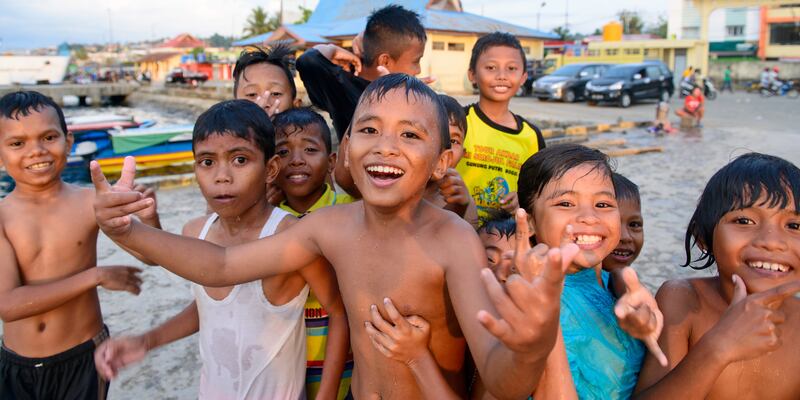 Local children run to welcome us as we walk the path from the harbour. Photograph: Gemma Tipton