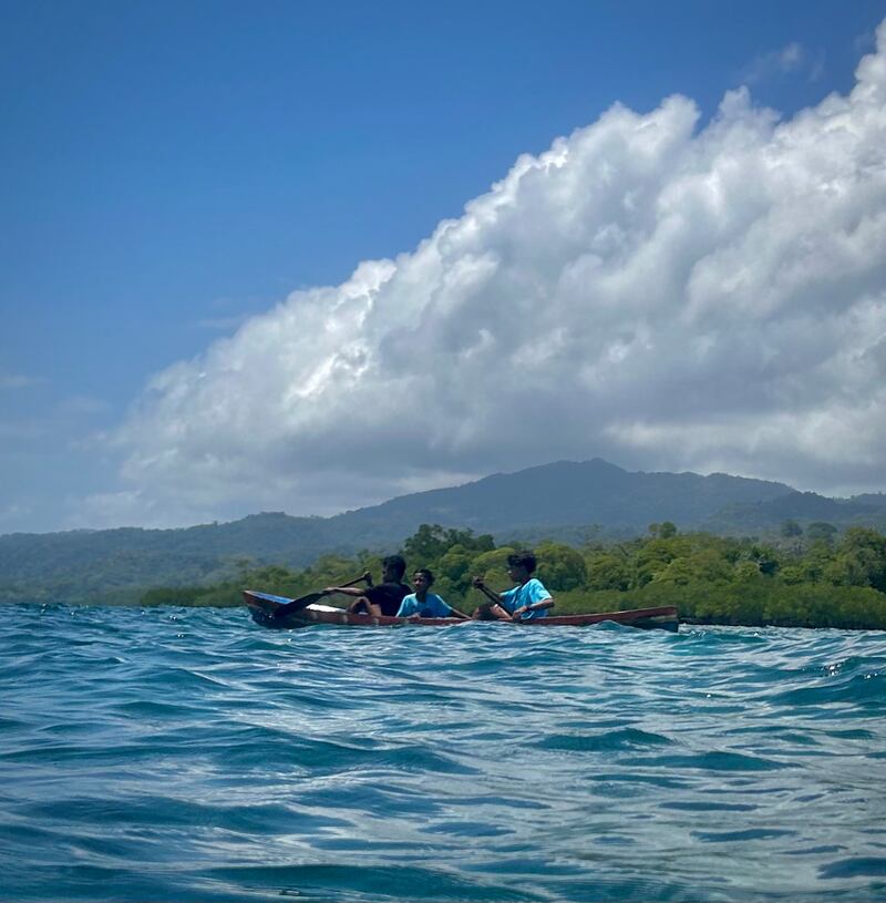 Local children canoeing by the Banda Islands. Photograph: Gemma Tipton