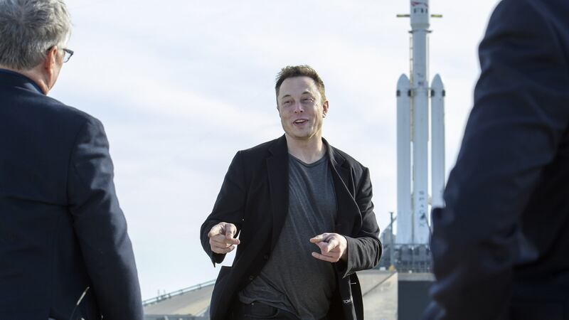 Elon Musk, founder of SpaceX, speaks to reporters, with the company’s Falcon Heavy rocket standing by. Photograph: Todd Anderson/New York Times