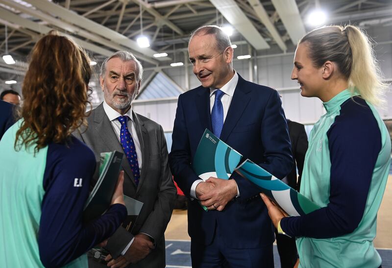 Kieran Mulvey with then taoiseach Micheál Martin and Irish Women's rugby players Emily Lane and Megan Burns. Photograph: David Fitzgerald/Sportsfile