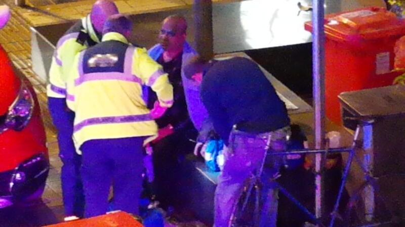 A man is treated at the scene. Photograph: Kevin Ponseel/@kponseel/Twitter