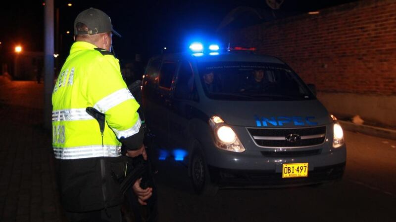 A  Colombian police officer watches a convoy transporting   John Jairo Velasquez Vasquez, alias ‘Popeye’,  from the Combita prison  in Boyaca,  Colombia. Photograph: Mauricio Duenas Castanea/EPA