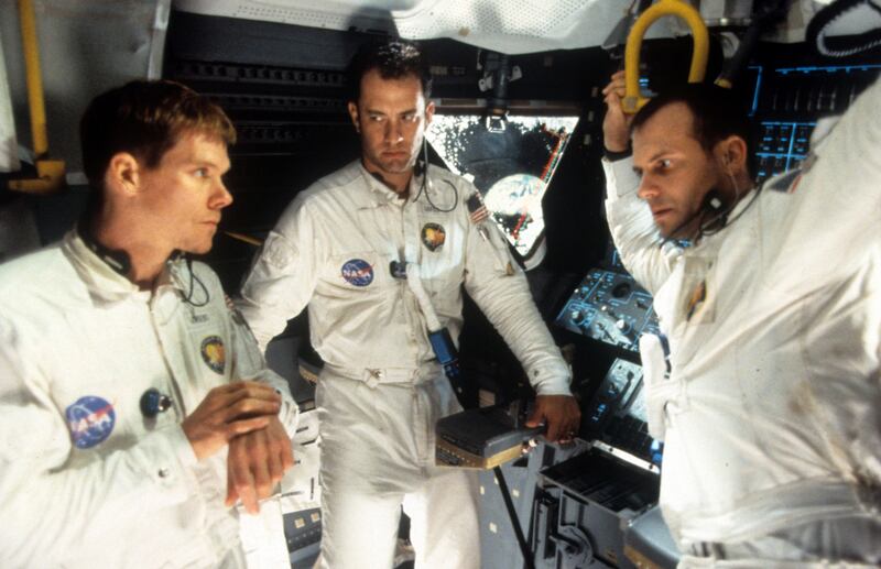 Kevin Bacon, Tom Hanks, and Bill Paxton talking in a scene from the film Apollo 13, 1995. Photograph: Universal/Getty Images.