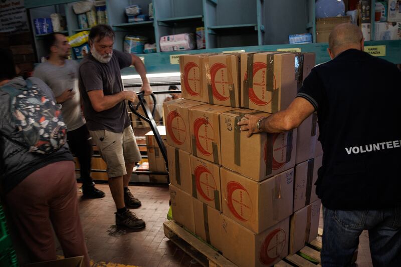 Volunteers from the 'Music For Peace humanitarian organisation' move boxes containing food stuff to be loaded on to boats in Genoa, and which will join the 'Global Sumud Flotilla', making there way for the Gaza Strip. Photograph: Getty Images