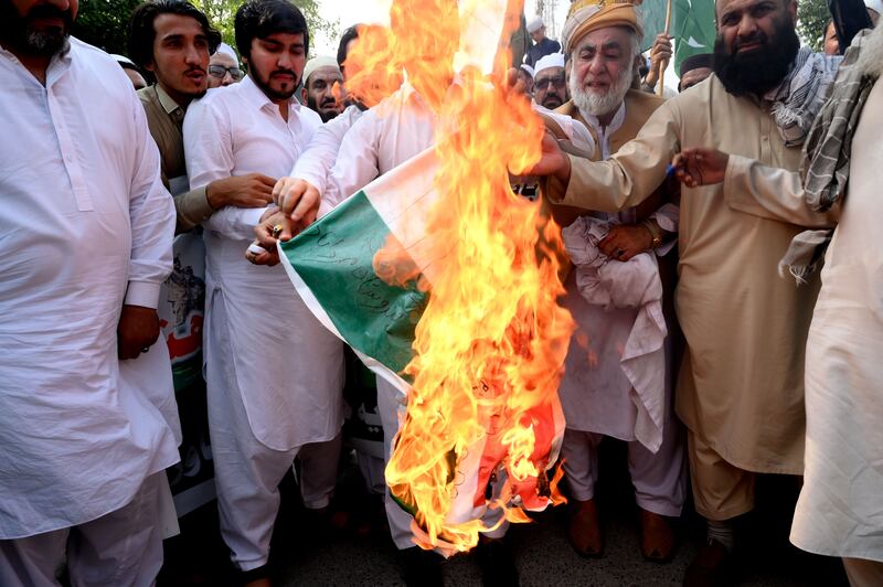 Supporters of different political parties burn an Indian flag while shouting anti-India slogans during a protest in Peshawar, Pakistan. Photograph: Shutterstock