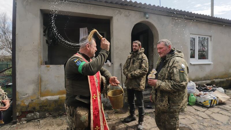 A military chaplain blesses Ukrainian soldiers near the northern city of Izyum on  April 24th. Photograph: EPA/STR