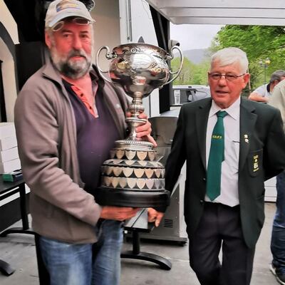 Tom Sweeney, winner of the Munster championships on Lough Leane in Killarney, being presented with the Munster Cup by Gerry Kenny