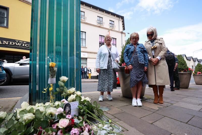 Ann Wilson (centre), who's daughter Lorraine died in the bombing, and Caroline Martin (right), who's sister Esther Gibson was also killed, mark the 25th anniversary at the memorial. Photograph: Liam McBurney/PA Wire