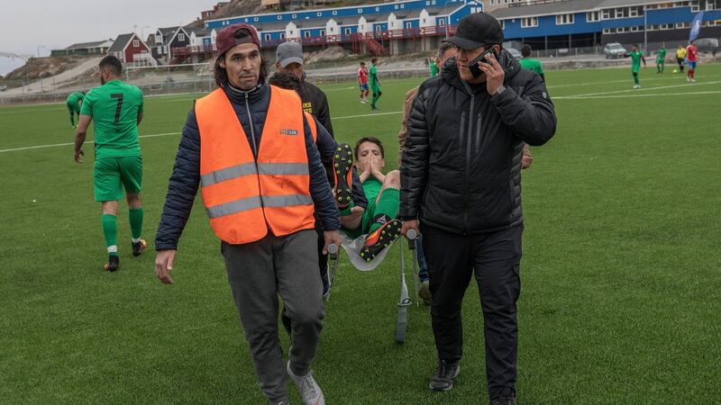 René Lennert Frederiksen, one of the soccer tournament’s organisers, calls for an ambulance after a GSS player is injured. Photograph: Kieran Dodds/New York Times