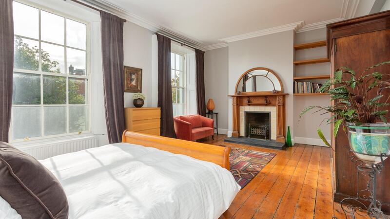 The main bedroom with the fanlight mirror above the mantle which is original to the house.