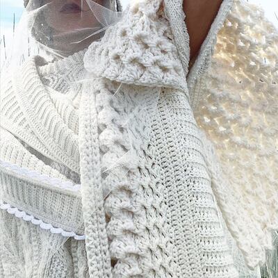 Detail of handknit and crochet coat and jumper by Colin Burke.