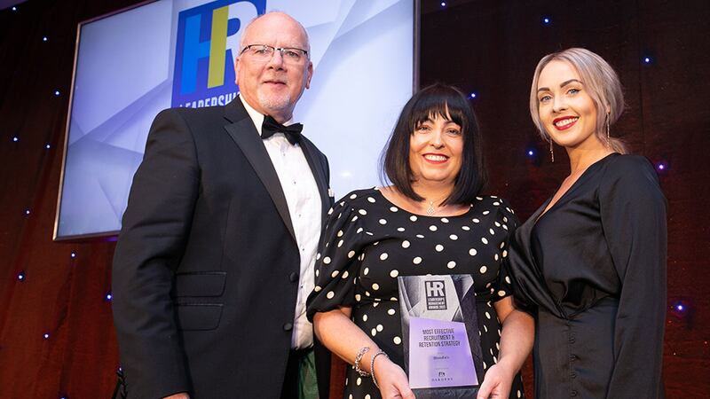 Jim Wylie, senior commercial development manager, and Emma Wilde, team lead - Human Resources Division, Osborne, presents the Most Effective Recruitment & Retention Strategy award to Sharon Kelly, Woodie's.