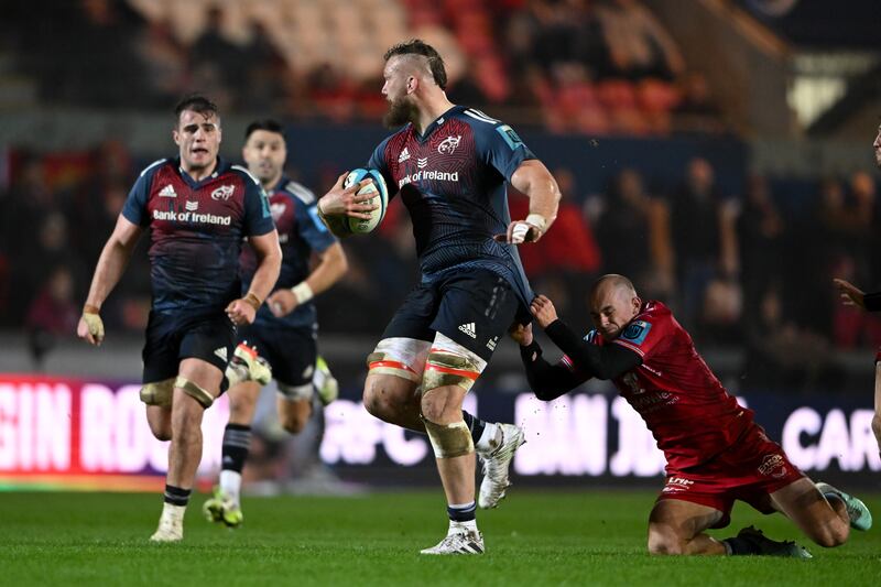 RG Snyman of Munster Rugby is tackled Ioan Nicholas of Scarlets. Photograph: Ashley Crowden/Inpho