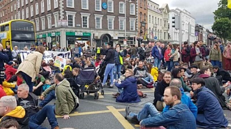 When the protesters encircled the bridge stewards urged people to sit down, thus blocking all entrances to the span from the quays. Photograph: The Irish Times