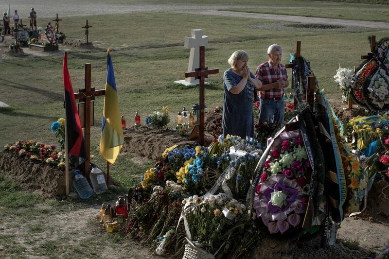 Mourners visit graves of Ukrainian soldiers in Lviv, Ukraine, on Sunday. Photograph: Emile Ducke/The New York Times