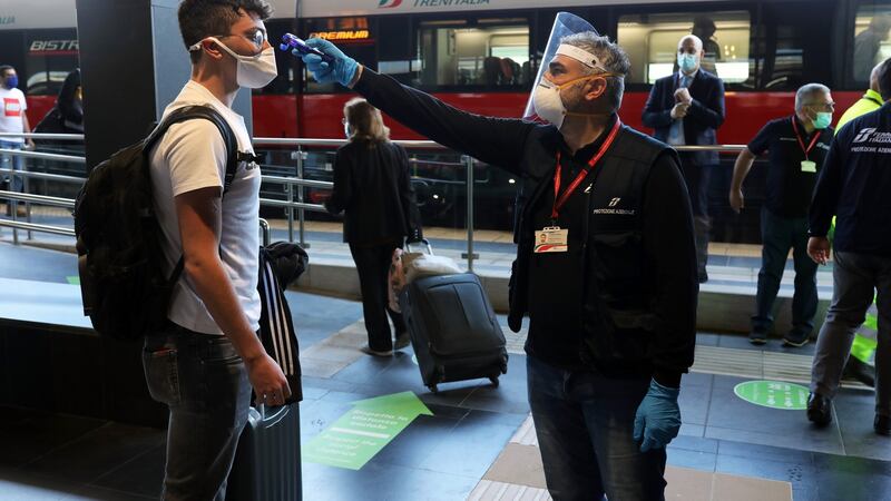 A train passenger in Reggio Calabria, Italy, has his temperature checked before boarding. Photograph: Getty