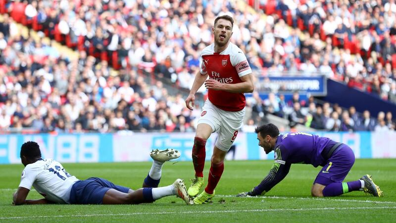 Aaron Ramsey wheels away after scoring the opener for Arsenal against Spurs. Photograph:  Clive Rose/Getty