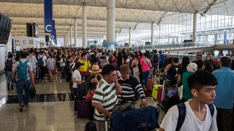 Passengers queue up as they wait to find out the status of their flights after Typhoon Nida caused chaos at the international airport in Hong Kong on August 2nd, 2016. Hordes of angry passengers stranded after Typhoon Nida pummelled Hong Kong crowded the airport on August 2nd, desperately seeking flights as the city emerges from lockdown while the storm swept across southern China. Photograph: Anthony  Wallace/AFP
