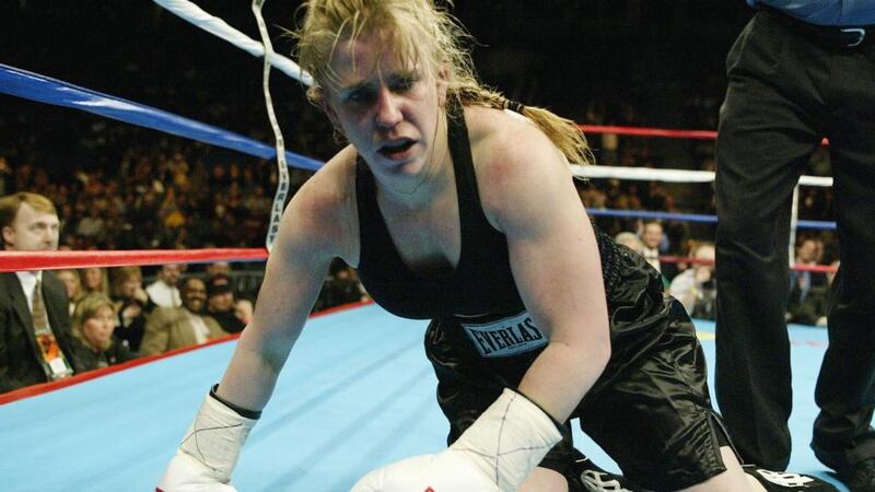 Tonya Harding falls to the floor during a fight with Samantha Browning in a second round during their women’s bantamweight bout  in 2003. Photograph: Al Bello/Getty Images