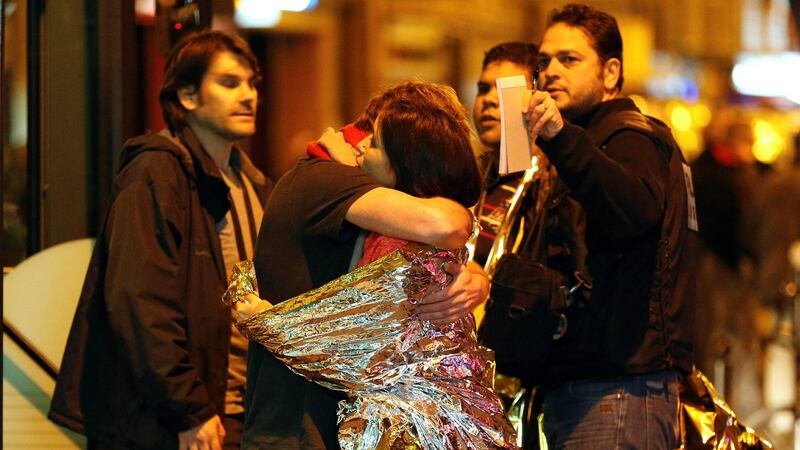 People hug each other before being evacuated by bus, near the Bataclan concert hall in central Paris, after a series of coordinated attacks in and around Paris. File photograph: Francois Guillot/AFP/Getty Images